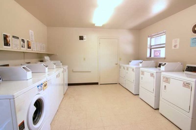 Photo of laundry room with multiple washers and dryers